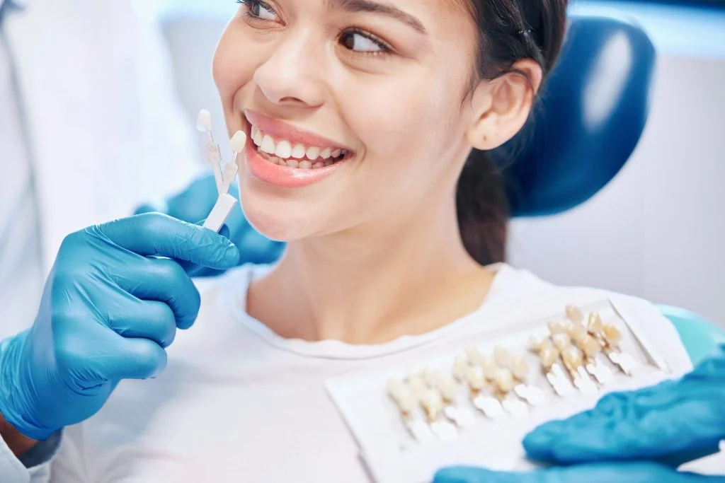Dentist woman and dental sample for veneers