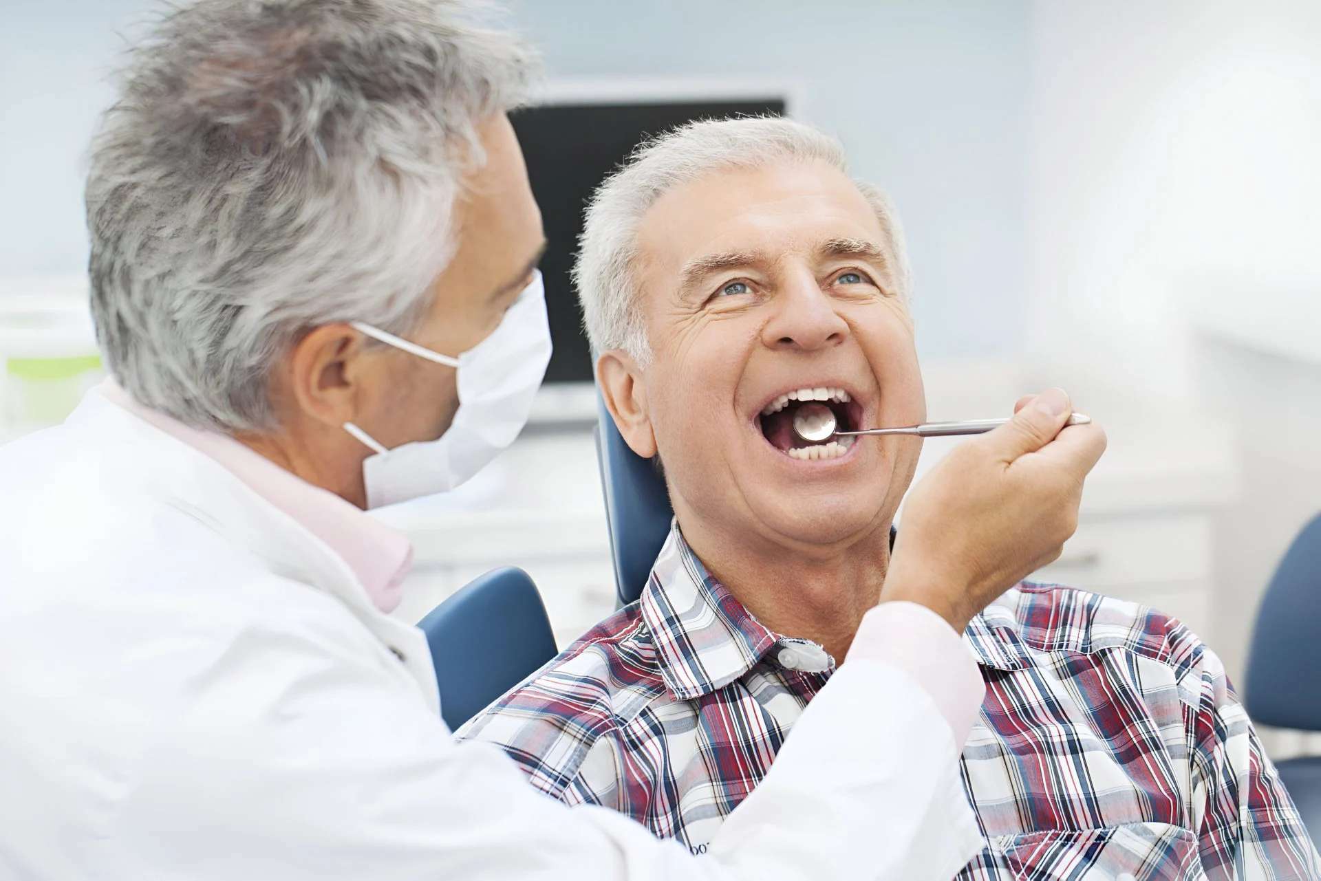 dentist with senior man during check up