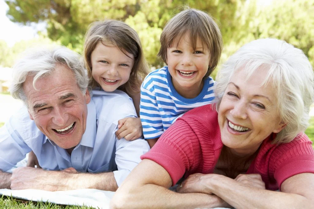 Grandparents And Grandchildren In Park Together